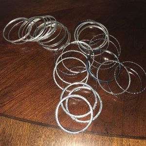 Bundle of silver tone bangle bracelets.